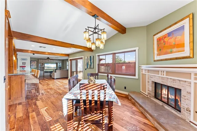 a living room with furniture a fireplace and dining table