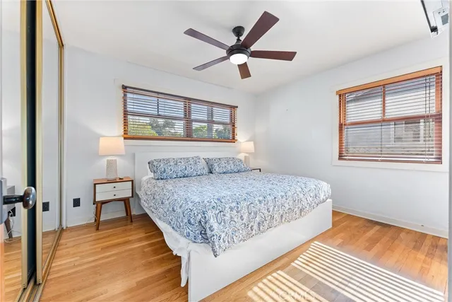 a bedroom with a bed and wooden floor