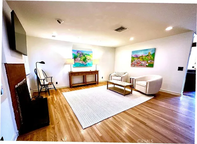 a bedroom with furniture and a flat screen tv