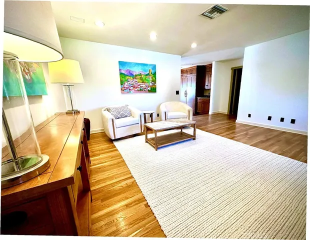 a spacious bedroom with a bed and lamp