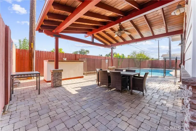 a view of a patio with a dining table and chairs
