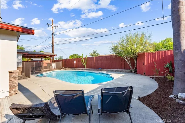 a outdoor dining space with furniture and umbrella