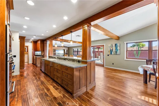 a large kitchen with stainless steel appliances granite countertop a large stove a sink and a refrigerator