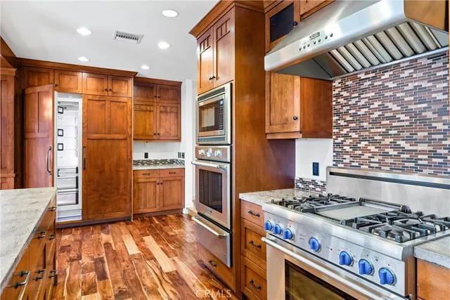 a kitchen with a stove and a refrigerator