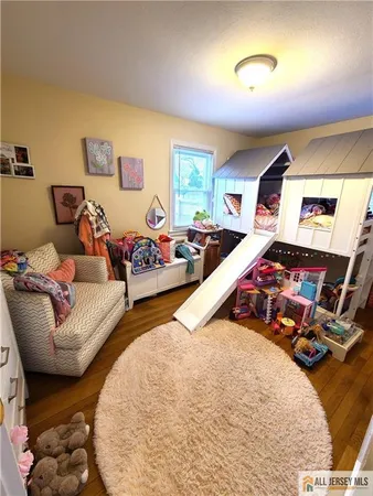 a bedroom with two beds and painting on the wall