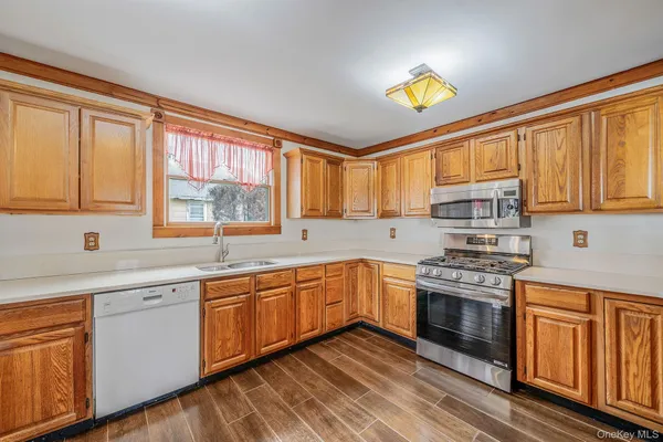 a kitchen with stainless steel appliances sink refrigerator and window