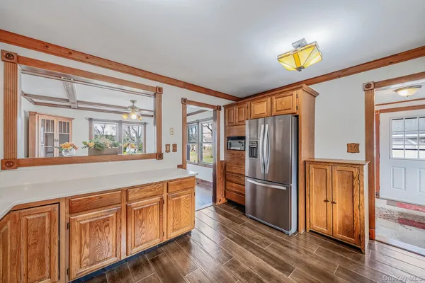 a large kitchen with stainless steel appliances granite countertop a sink and cabinets