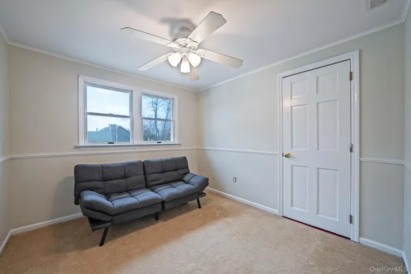 a bedroom with a bed and ceiling fan