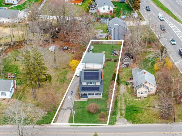 aerial view of a house with a yard