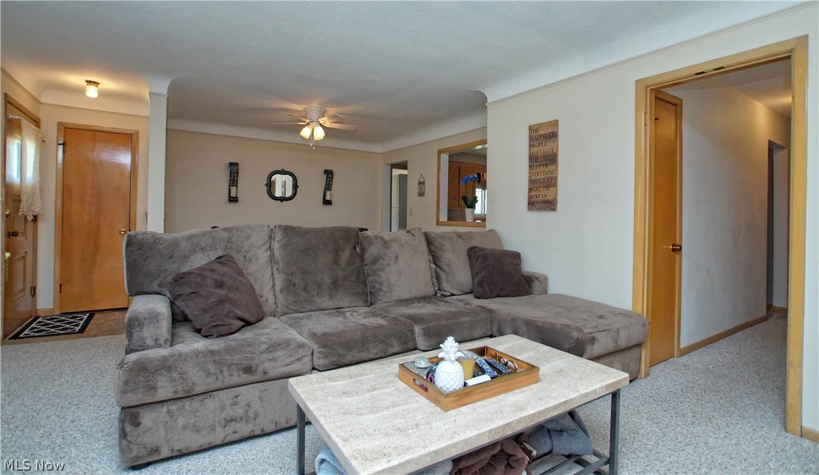 8601 Royal Ridge Drive Parma, OH 44129 - Photo 5 of 33 Carpeted living room with lighted ceiling fan.