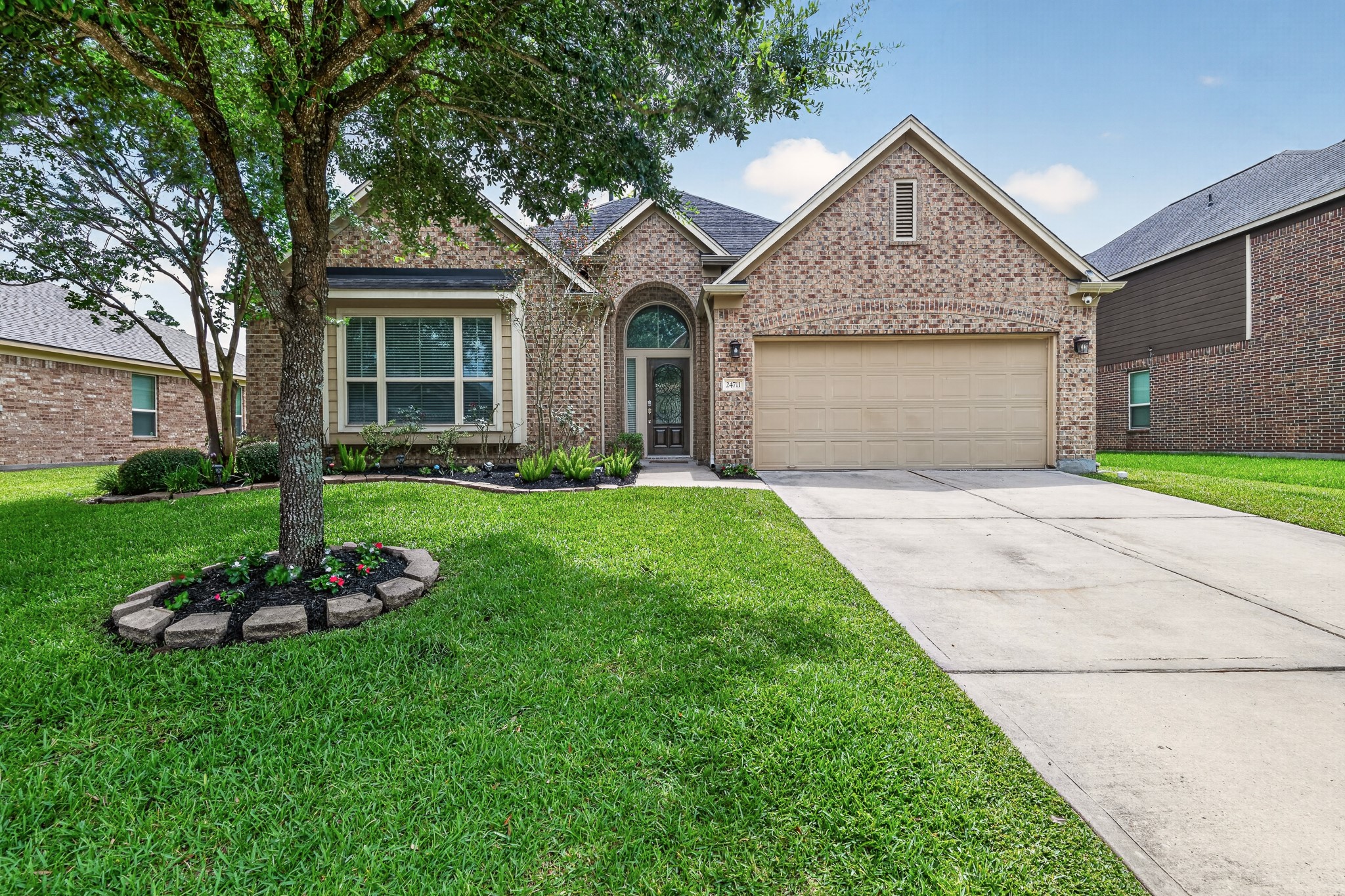 24711 East Burnaby Circle Spring, TX 77373 - Photo 20 of 20 a front view of a house with a yard and garage