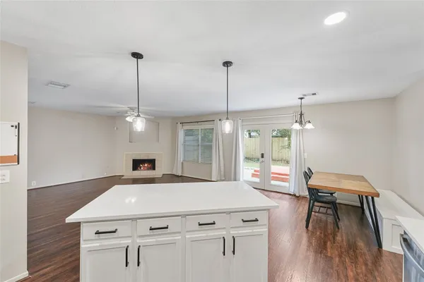 a view of a room with furniture and wooden floor