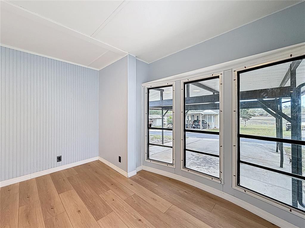 9569 Gray Fox Drive Weeki Wachee, FL 34613 - Photo 11 of 27 wooden floor in an empty room with a window