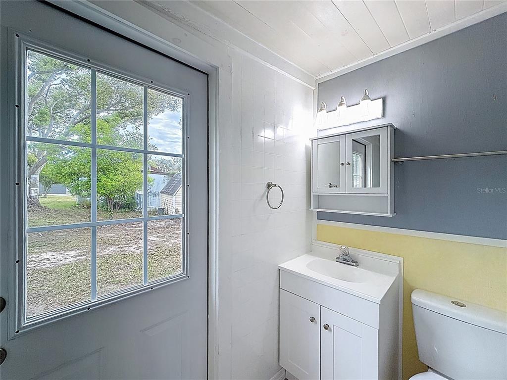 9569 Gray Fox Drive Weeki Wachee, FL 34613 - Photo 17 of 27 a bathroom with a toilet sink and mirror