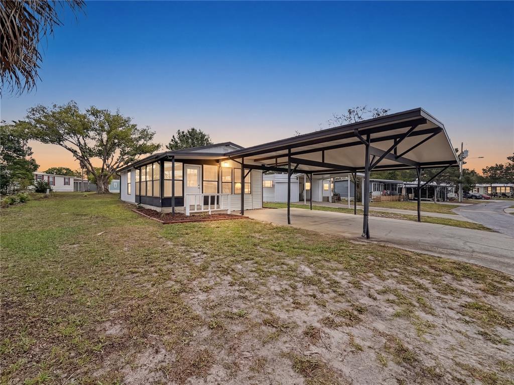 9569 Gray Fox Drive Weeki Wachee, FL 34613 - Photo 2 of 27 a view of a house with backyard and porch