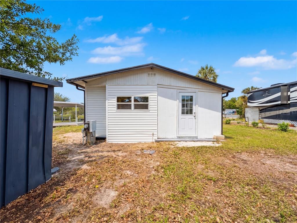 9569 Gray Fox Drive Weeki Wachee, FL 34613 - Photo 23 of 27 a view of a house with a yard