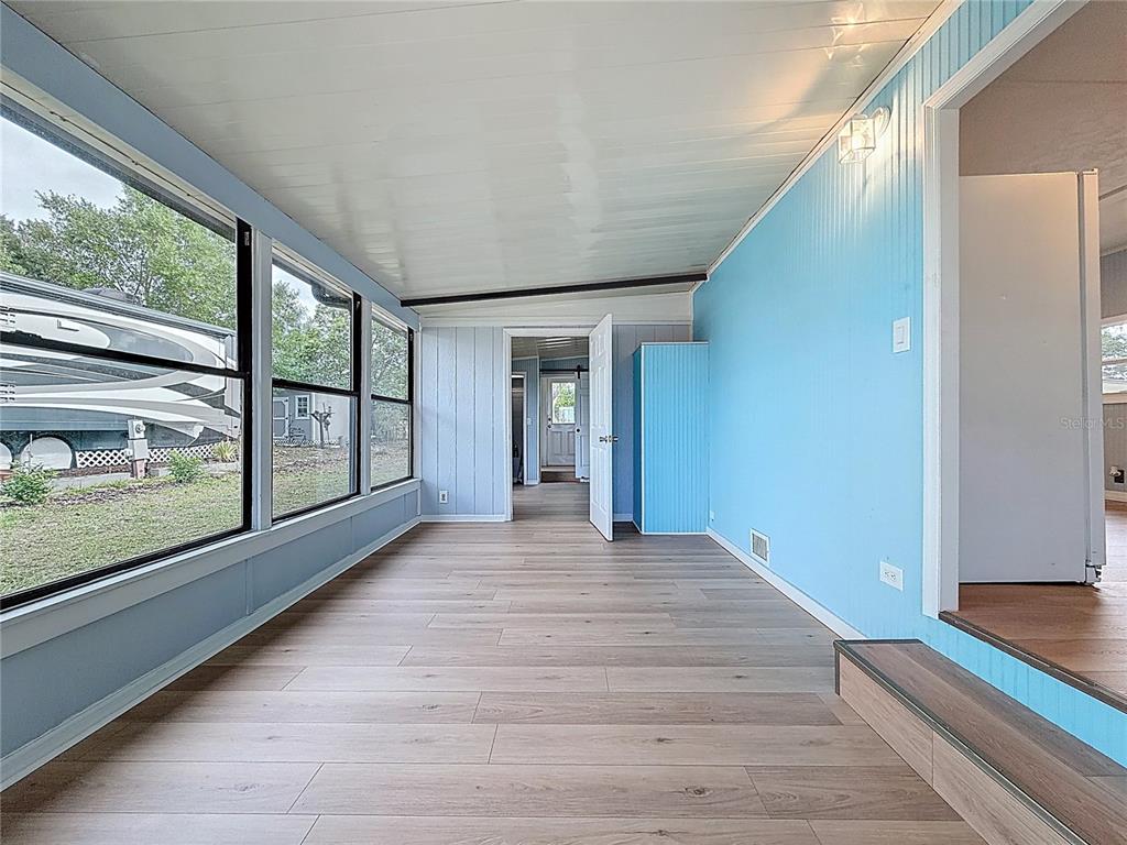 9569 Gray Fox Drive Weeki Wachee, FL 34613 - Photo 5 of 27 a view of an entryway with wooden floor and door