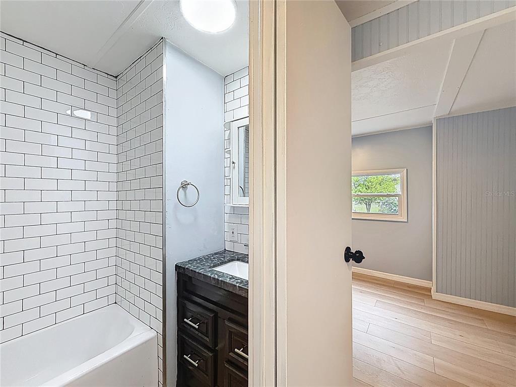 9569 Gray Fox Drive Weeki Wachee, FL 34613 - Photo 7 of 27 a bathroom with a bathtub and a shower