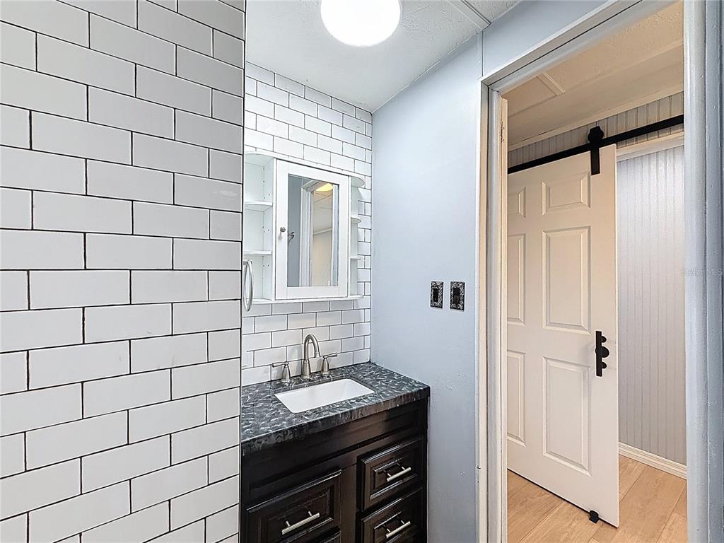 9569 Gray Fox Drive Weeki Wachee, FL 34613 - Photo 8 of 27 a bathroom with a sink and a mirror