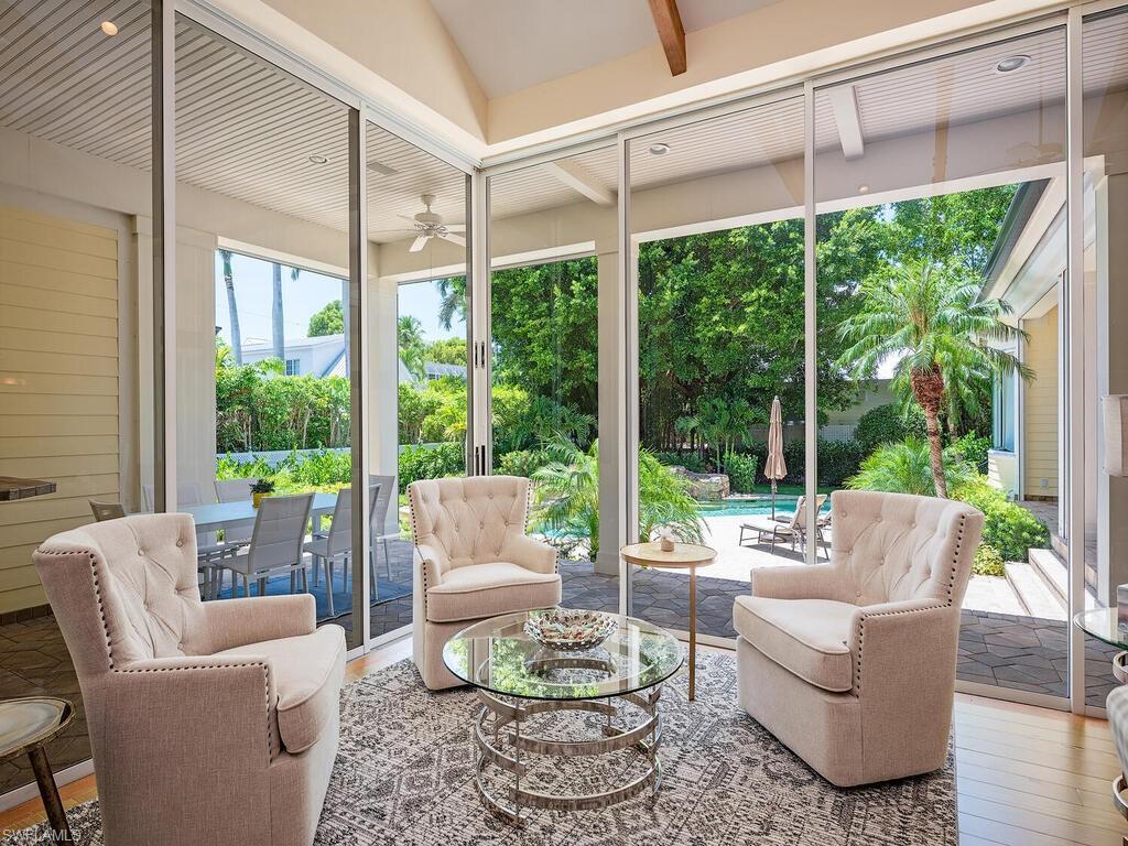 194 4th Avenue North Naples, FL 34102 - Photo 16 of 37 a living room with furniture and a large window with garden view