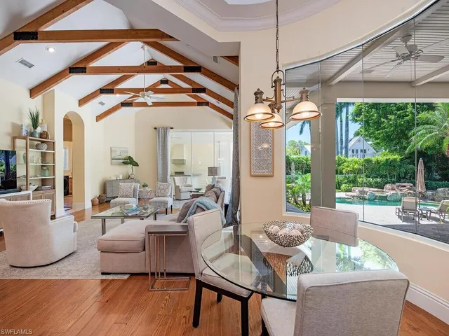 a living room with furniture a window and wooden floor