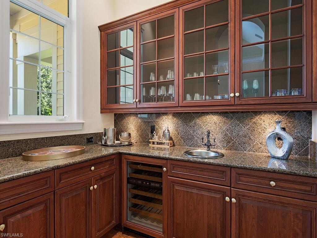 194 4th Avenue North Naples, FL 34102 - Photo 22 of 37 a kitchen with granite countertop a oven and cabinets
