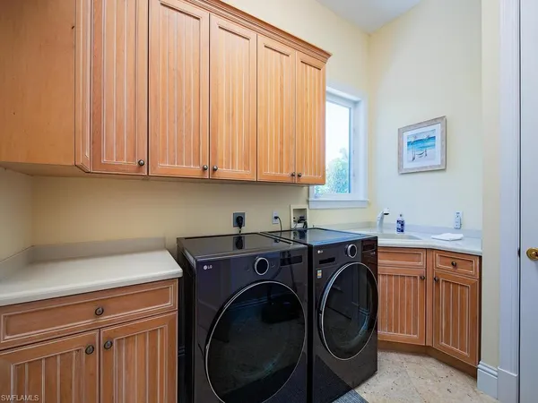 a utility room with sink dryer and washer