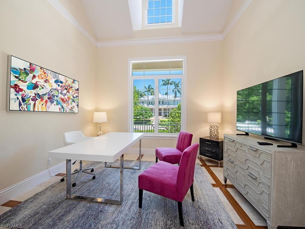194 4th Avenue North Naples, FL 34102 - Photo 24 of 37 a living room with furniture a flat screen tv and a window