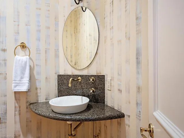 a bathroom with a sink and mirror