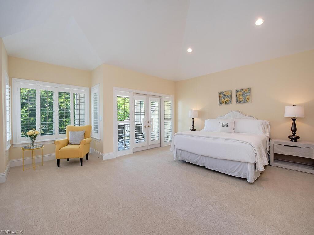 194 4th Avenue North Naples, FL 34102 - Photo 26 of 37 a spacious bedroom with a bed and large window
