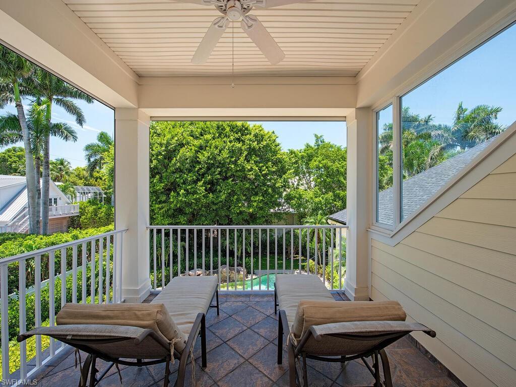 194 4th Avenue North Naples, FL 34102 - Photo 28 of 37 a view of a chair in wooden deck
