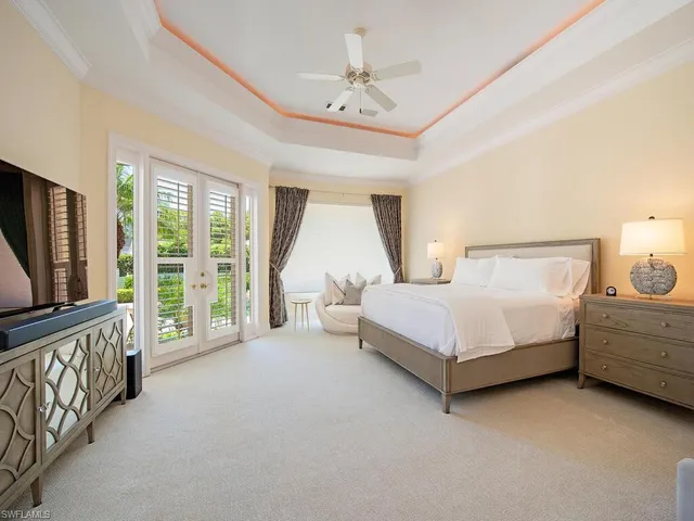 a bed room with a bed and a television