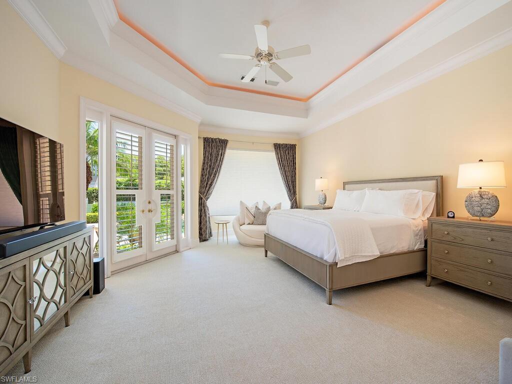 194 4th Avenue North Naples, FL 34102 - Photo 35 of 37 a bed room with a bed and a television