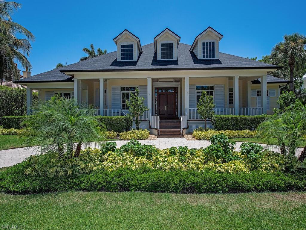 194 4th Avenue North Naples, FL 34102 - Photo 6 of 37 a front view of a house with a yard