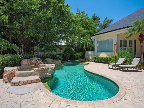 a view of a house with backyard sitting area and garden