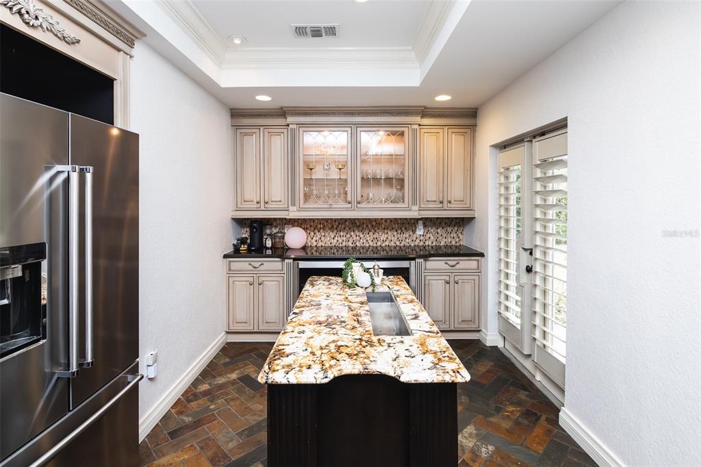 1001 Nottingham Street Orlando, FL 32803 - Photo 9 of 49 a kitchen with stainless steel appliances kitchen island granite countertop a refrigerator stove and oven