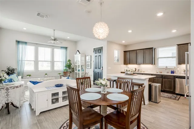 a kitchen with a sink a refrigerator and wooden cabinets