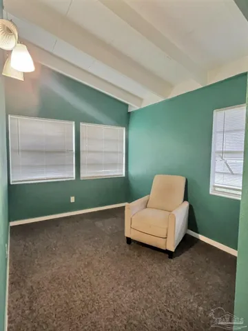a living room with a bed furniture and a window