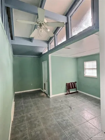 a view of a livingroom with a ceiling fan and window