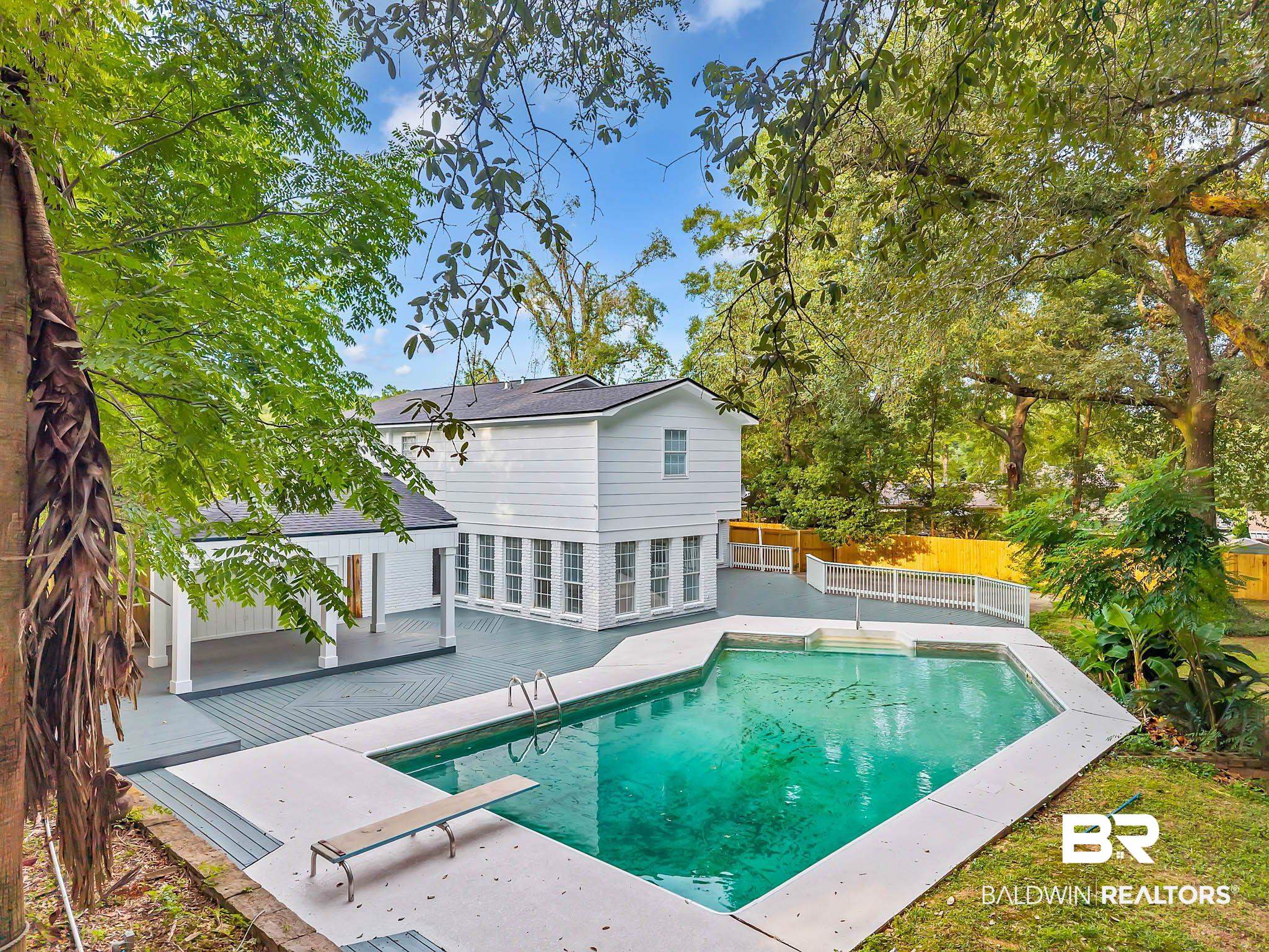 4705 Sherry Court Mobile, AL 36693 - Photo 65 of 100 View of swimming pool featuring a fenced backyard, a diving board, and a patio