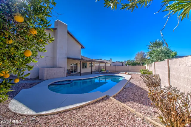 an empty room with wooden floor and ceiling fan
