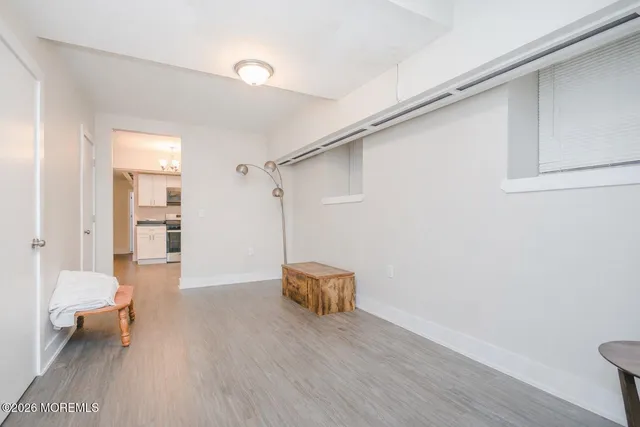 a hallway with a furniture and a wooden floor