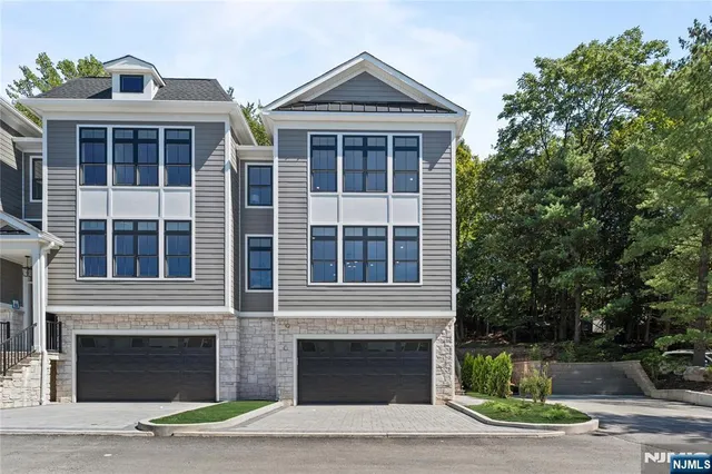 a living room with furniture fireplace and a large window