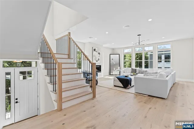 a view of kitchen with wooden floor and cabinets
