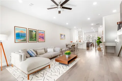 a living room with furniture and wooden floor