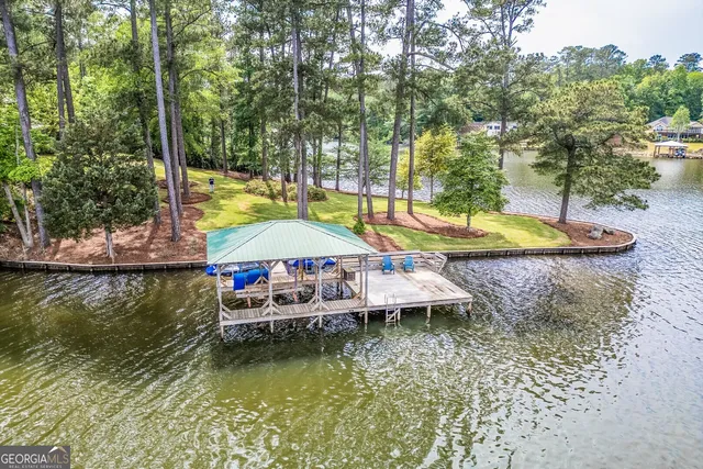 a dining room with furniture a chandelier and wooden floor
