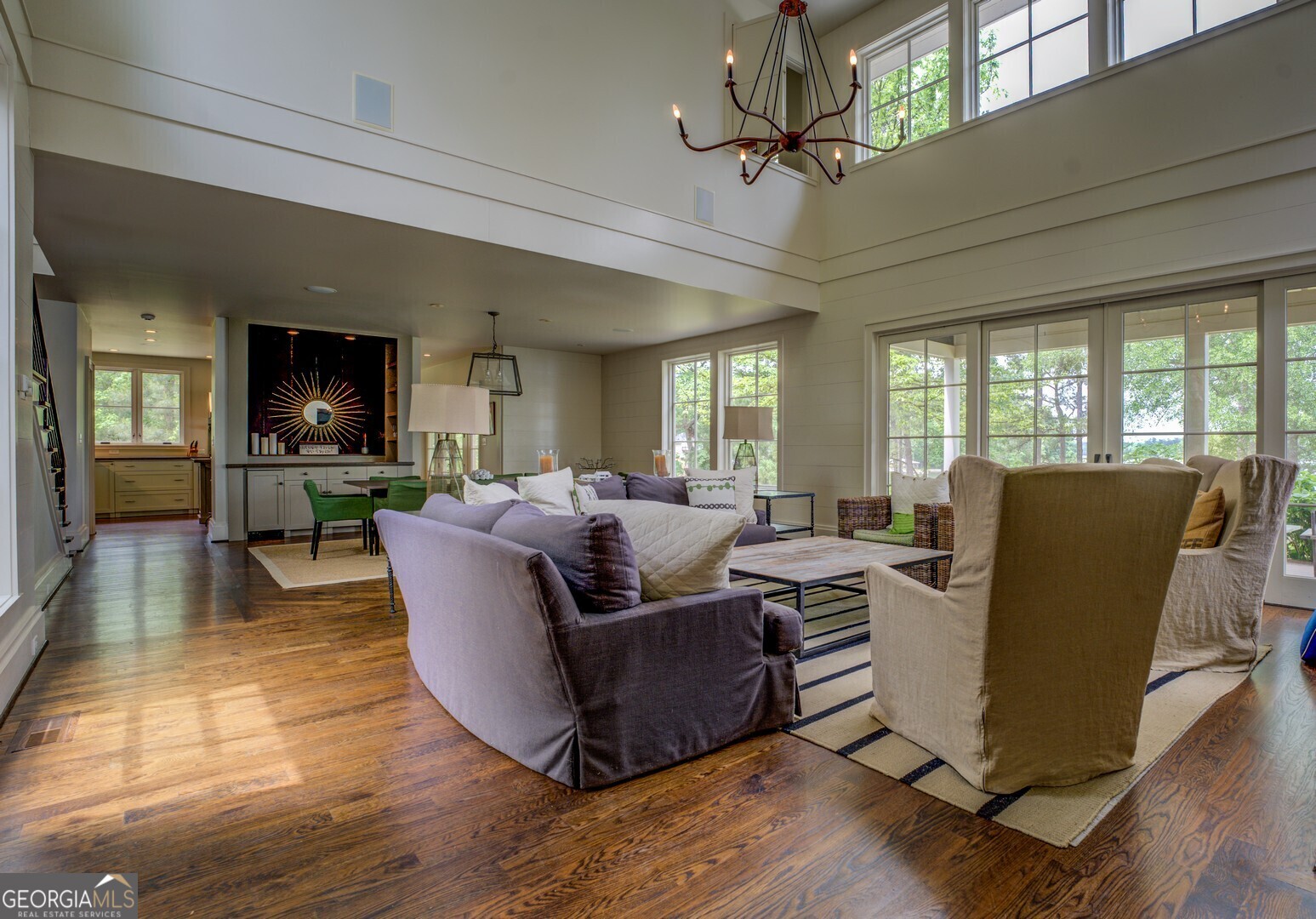 172 Tater Hill Road Jackson, GA 30233 - Photo 18 of 84 a living room with furniture a chandelier and a dining table with wooden floor