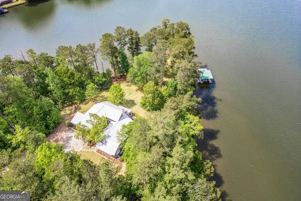 an aerial view of a houses with a lake view