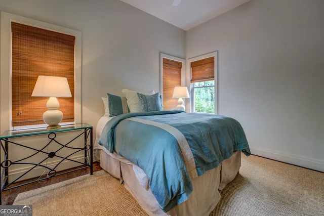 a front view of a house with a yard and trees