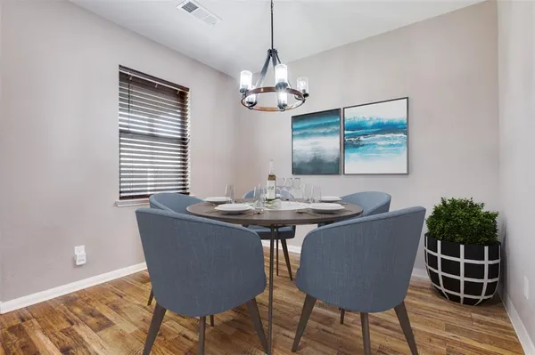 a view of a dining room with furniture window and wooden floor
